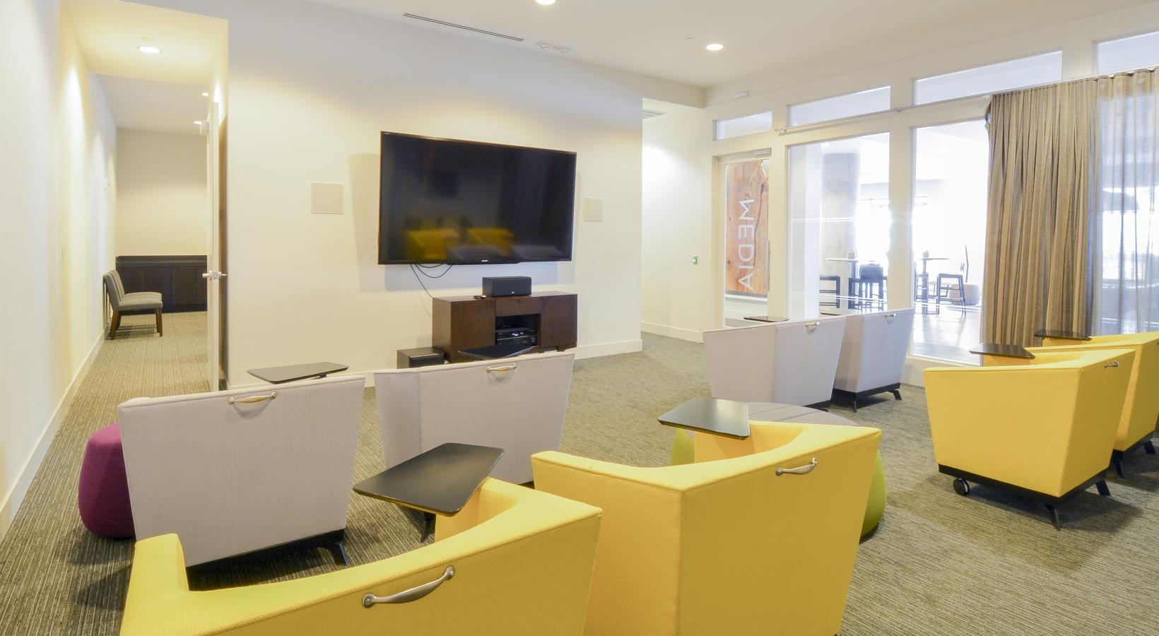 Take advantage of all 75 Tresser has to offer a room with yellow chairs and a tv on the wall