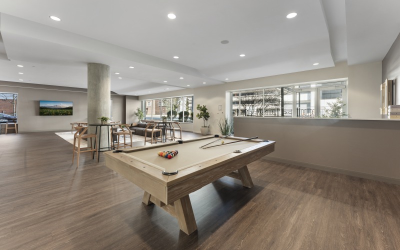 Resident game room and lounge at 75 Tresser in Stamford CT featuring billiards, comfortable seating, and social spaces.