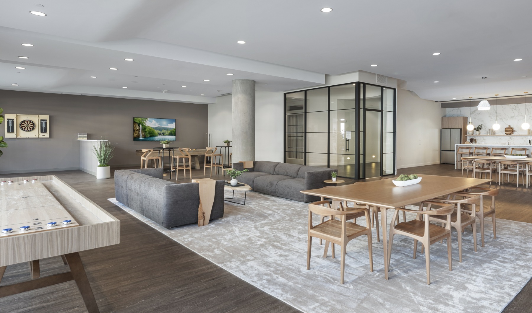 Modern resident lounge at 75 Tresser apartments in Stamford CT featuring a communal dining table and contemporary seating.