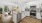 Model kitchen at our apartments for rent in Stamford, CT, featuring wood grain floor paneling and stainless steel appliances.